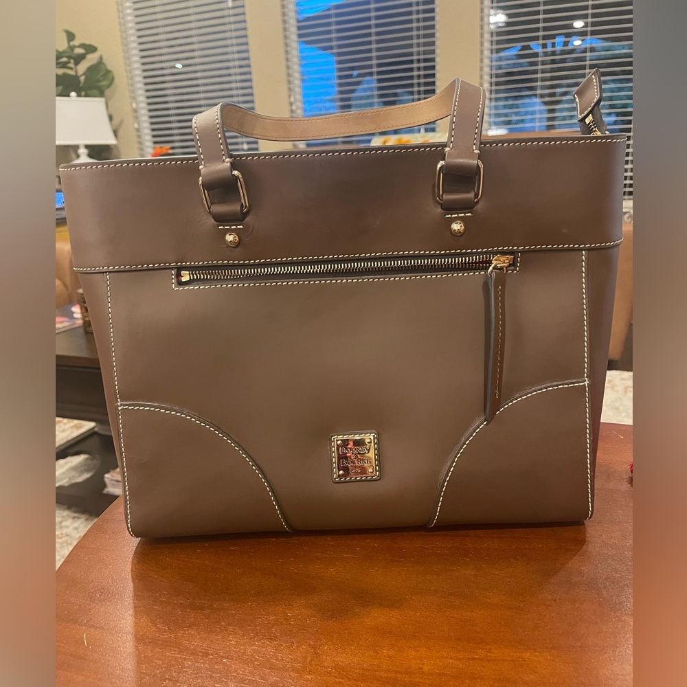 Dooney Bourke Brown Leather bag with red interior.